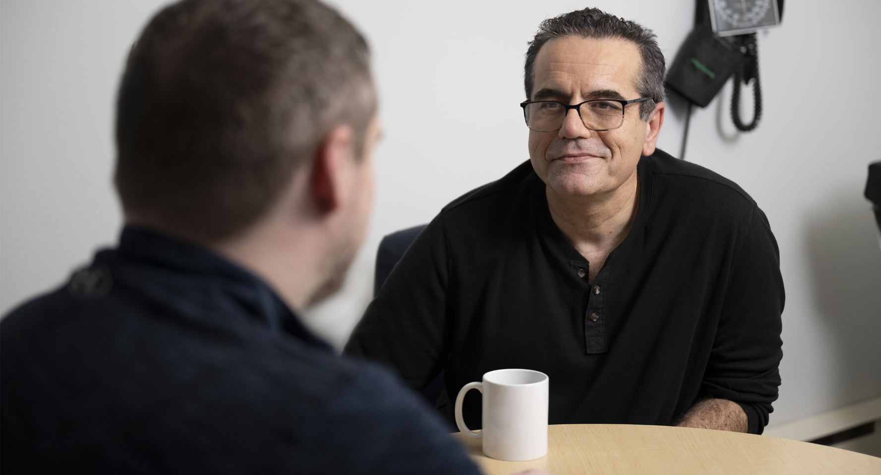 A photo of Dr. Reza Mehrpooya having coffee with a patient