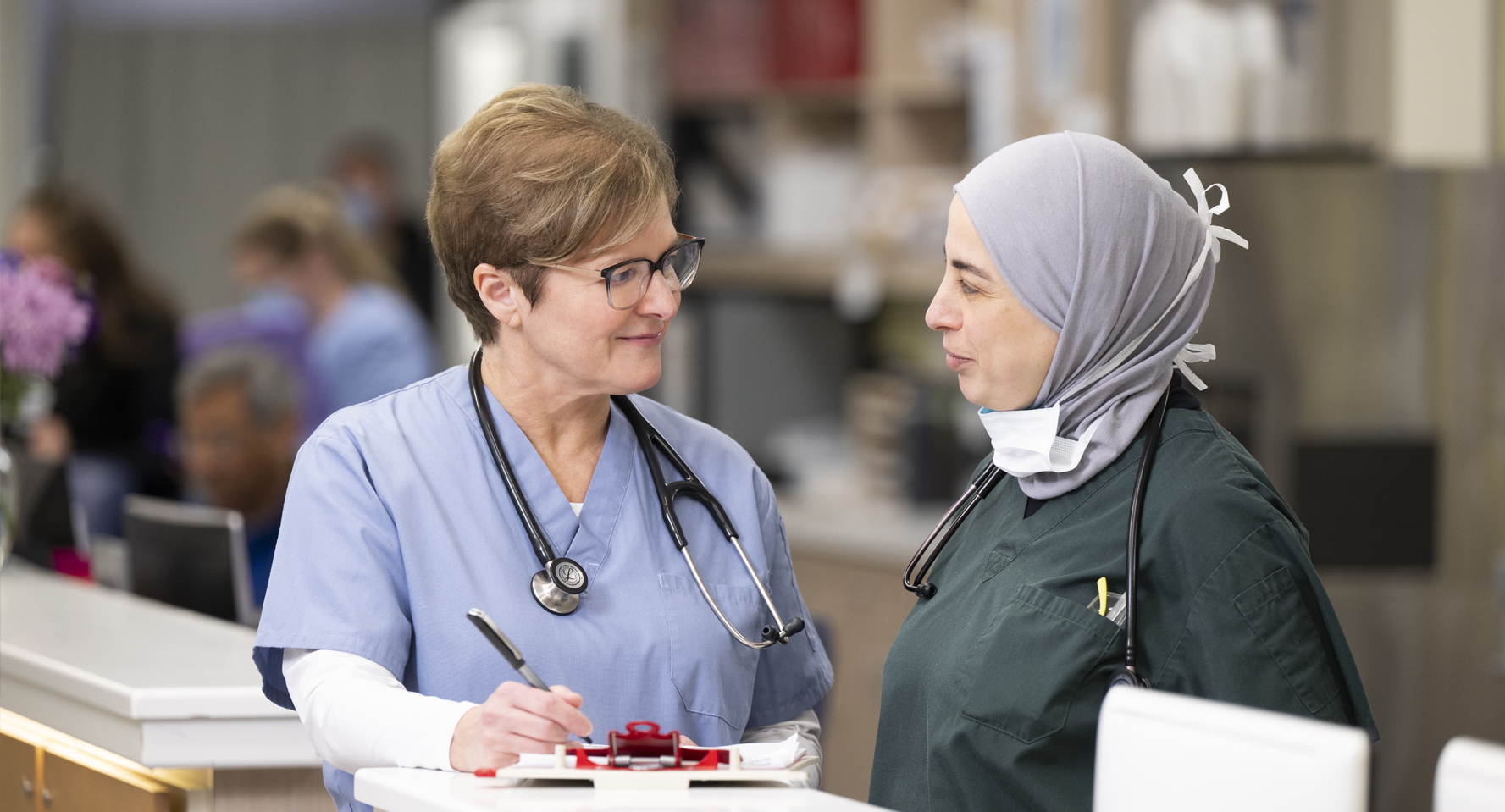A photo of Dr. Deborah Straub and a female colleague wearing scrubs in the emergency department